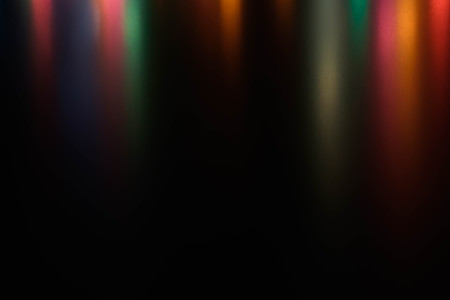 Sparkles garland texture multicolored blur festive on black background.