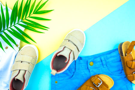 Sneakers and sandals on a trendy color background, top view, summer shoes. Flat lay.の写真素材