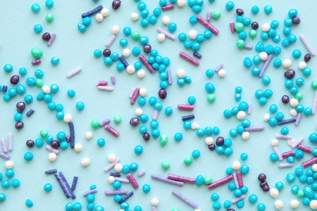 Colorful holiday background with candy on blue. Copy space for text. Greeting card for Easter, birthday. Flat lay .Top view.の写真素材
