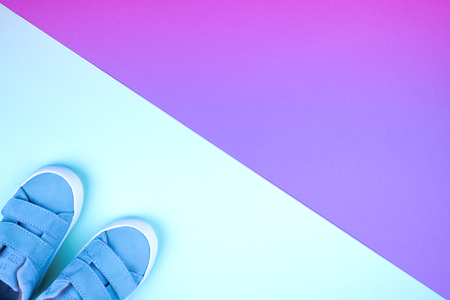 Sneakers on a trendy neon color background, top view, summer shoes. Flat lay. Copy space.の写真素材