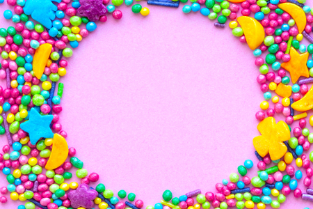 Colorful holiday background with candy on pink. Copy space for text. Greeting card for Easter, birthday. Flat lay .Top view.の写真素材