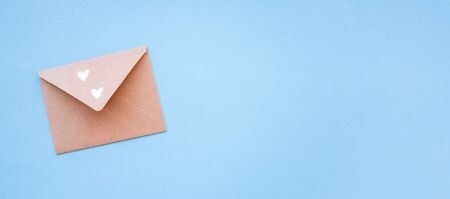 Paper envelope on a blue background with a golden heart.