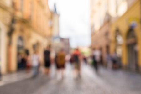 Blurred background with walking people on the street in old city.の写真素材