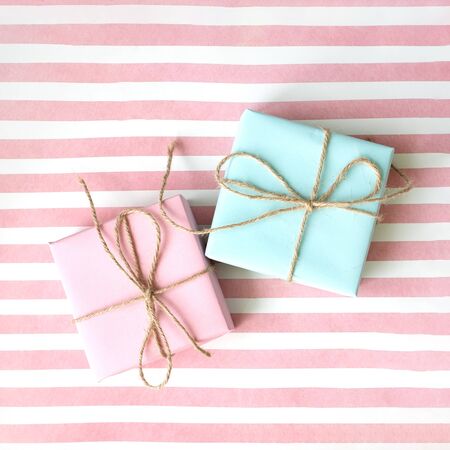 Pink and blue gift box on a pink background . Holiday concept. Copy space. Flat lay.の写真素材
