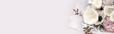 Close-up bouquet of flowers on a pink background, spring tulips of white color with hyacinth and buttercup. Banner with place for text and your advertisement.の写真素材