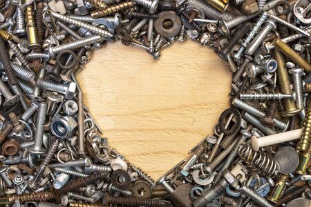 Nuts bolts screws nails arranged into a heart shape as a Fathers Day concept flat lay shoot from...