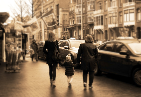 two women walking with a childの写真素材