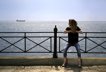 girl looking at the seaの写真素材
