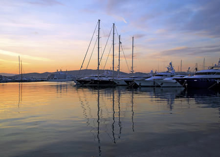 boat reflection in the sea with a colorful sunset