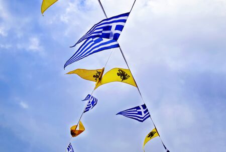 greek and byzantine flags above the blue skyの写真素材
