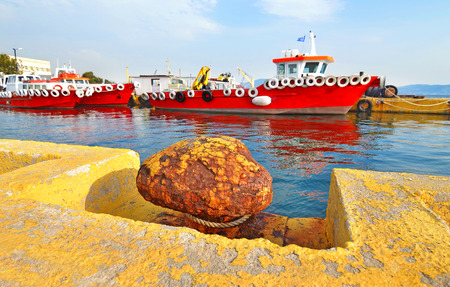 rusty mooring and red ships at Eleusis port Greeceの写真素材