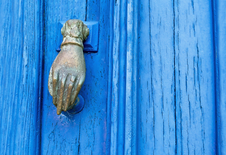 Cyclades architecture - metallic door knocker hand - old blue wooden doorの写真素材