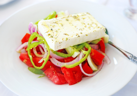 traditional greek salad with the white cheese feta at a tavernの写真素材