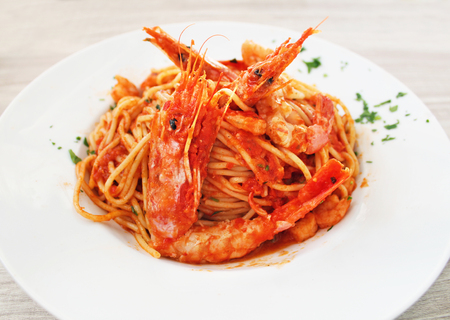 plate with shrimps, spaghetti and tomato sauce at a greek tavern - mediterranean seafoodの写真素材