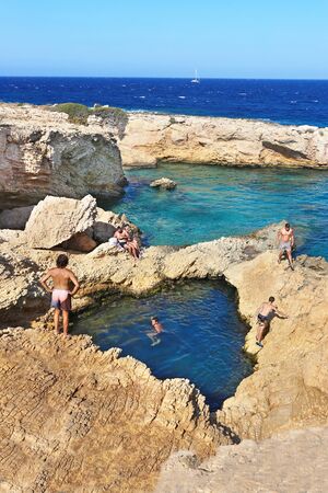 ANO KOUFONISI GREECE, AUGUST 27 2019: people swimming in the natural pool of the sea between the rocks at Ano Koufonisi island Greece. Editorial use.のeditorial素材