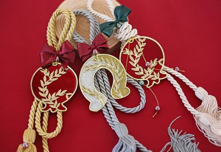 decorative Christmas lucky charms on red background - lucky horseshoe and pomegranate