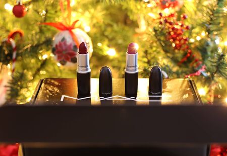 ATHENS GREECE, DECEMBER 28 2019: still life of MAC cosmetics famous brand in front of the Christmas tree - MAC lipsticks. Editorial use.のeditorial素材