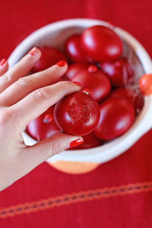 hand holding cracked Easter egg - traditional greek Easter eggsの写真素材