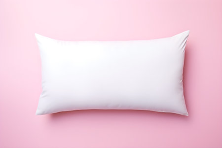 White pillow on pink background. Flat lay, top view, copy spaceの素材