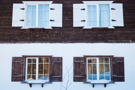 Four windows in the house double color with open shuttersの写真素材