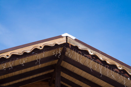 Closeup shows the edge of the roof with decorative trim.の写真素材