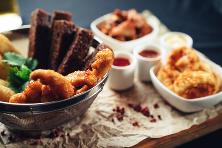 fried appetizer beer sidedish on cutting boardの写真素材