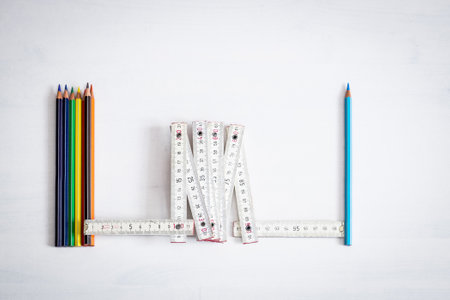 Safe school concept, group of colored crayons separated by the single one-meter light blue crayon to...