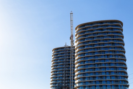 Building crane and construction site under blue skyの写真素材