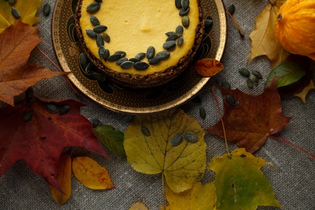 Delicious pumkin cake with leaves on background.の写真素材