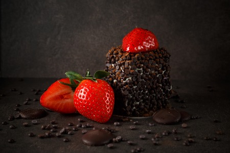 Piece of chocolate cake with fresh berry on dark backgroundの写真素材