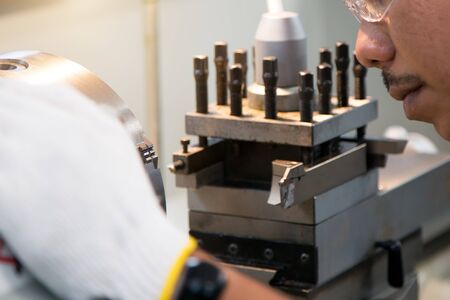 man doing part machinery by grinding machine
