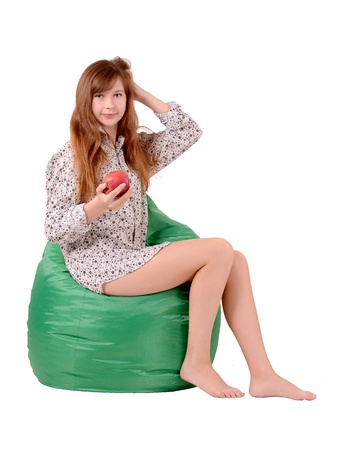 girl sitting on a green pufeの写真素材
