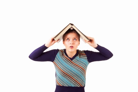 Girl with an open book on her head, in the form of house