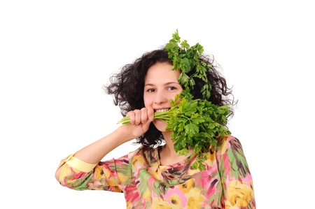 girl biting a green parsleyの写真素材
