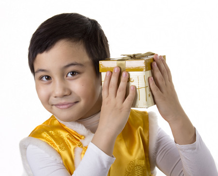Child listen what is in the boxの写真素材