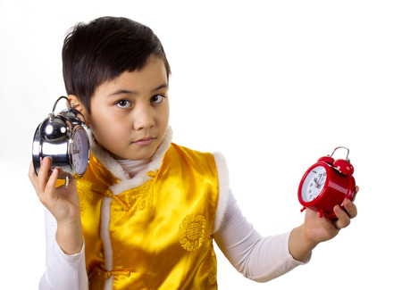 boy with clocks and listen one of themの写真素材