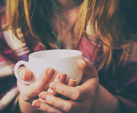 Girl with the coffee cup and plaid.