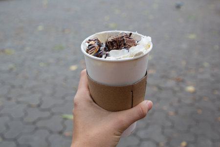 whiped cream on late coffe to goの写真素材