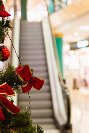 christmas tree with lights in shopping mall during holidayの写真素材