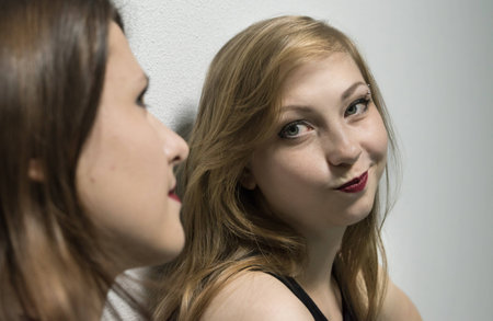 Two girls models posing for a photoの写真素材