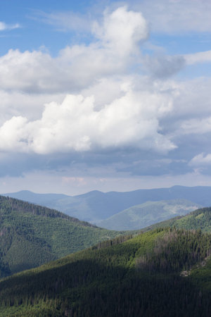 Green mountain hills and blue cloudy sky landscape