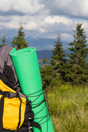 Backpack on the mountain top during hiking walkの写真素材