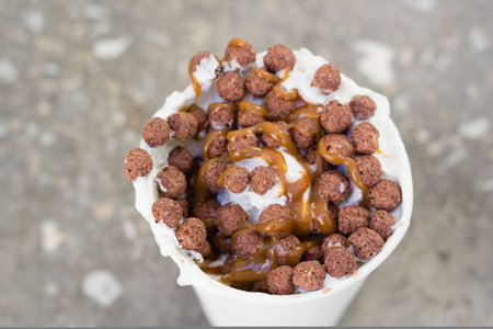 whiped cream and chocolate crisps on late coffe to goの写真素材