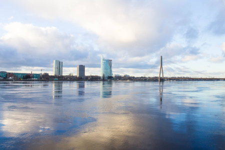 Sunset light over bridge and river in Riga, Latviaの写真素材