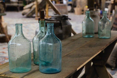 Big empty glass bottle on wooden tableの写真素材