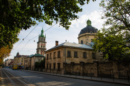 Lviv, Ukraine: Panorama of Pidvalna street with the tall bell tower of Dormition church and the dome of Dominican Church and empty street and trees framingの写真素材