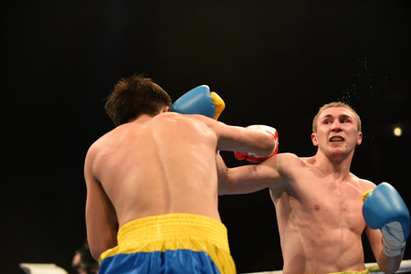Kyiv, UKRAINE - March 20, 2015 : PRUDKYI Oleg (UA) and SHAN Jun (China)  in the ring during boxing fight Ukraine Otamans vs China Dragons in Palace of Sport in Kiev, Ukraineのeditorial素材