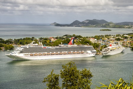 Castries, st.Lucia-November 26, 2015: Cruise ship Carnival Liberty and smaller ship standing in bay Of Castries, st.Lucia at sunny dayのeditorial素材