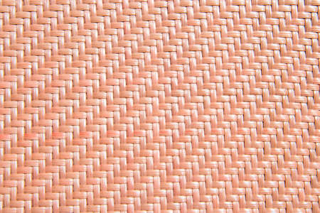 textured knitted background orange color of plastic material with nobody