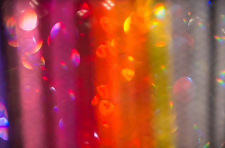 sparkling colorful abstract bokeh background yellow orange red and violet color with glitter circles with no peopleの写真素材